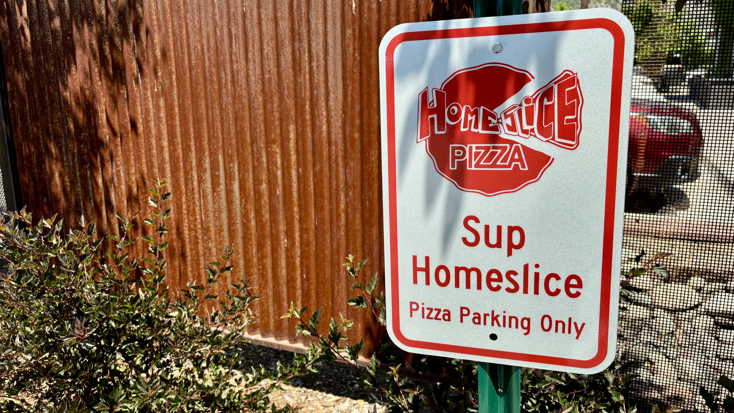 The 'Sup Homeslice — Pizza Parking Only' sign at HomeSlice Pizza North Main