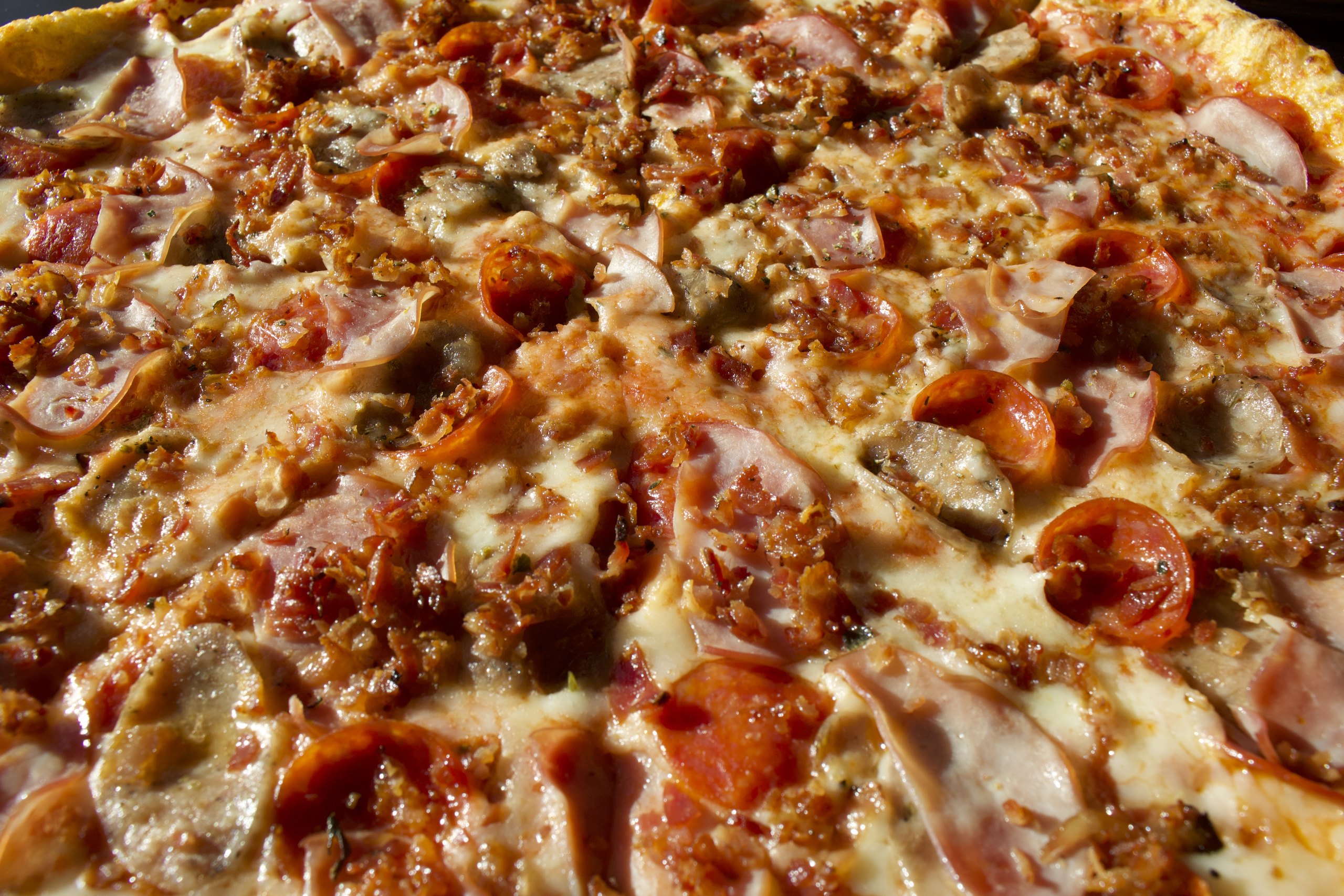 Close-up of a hearty HomeSlice meat pizza