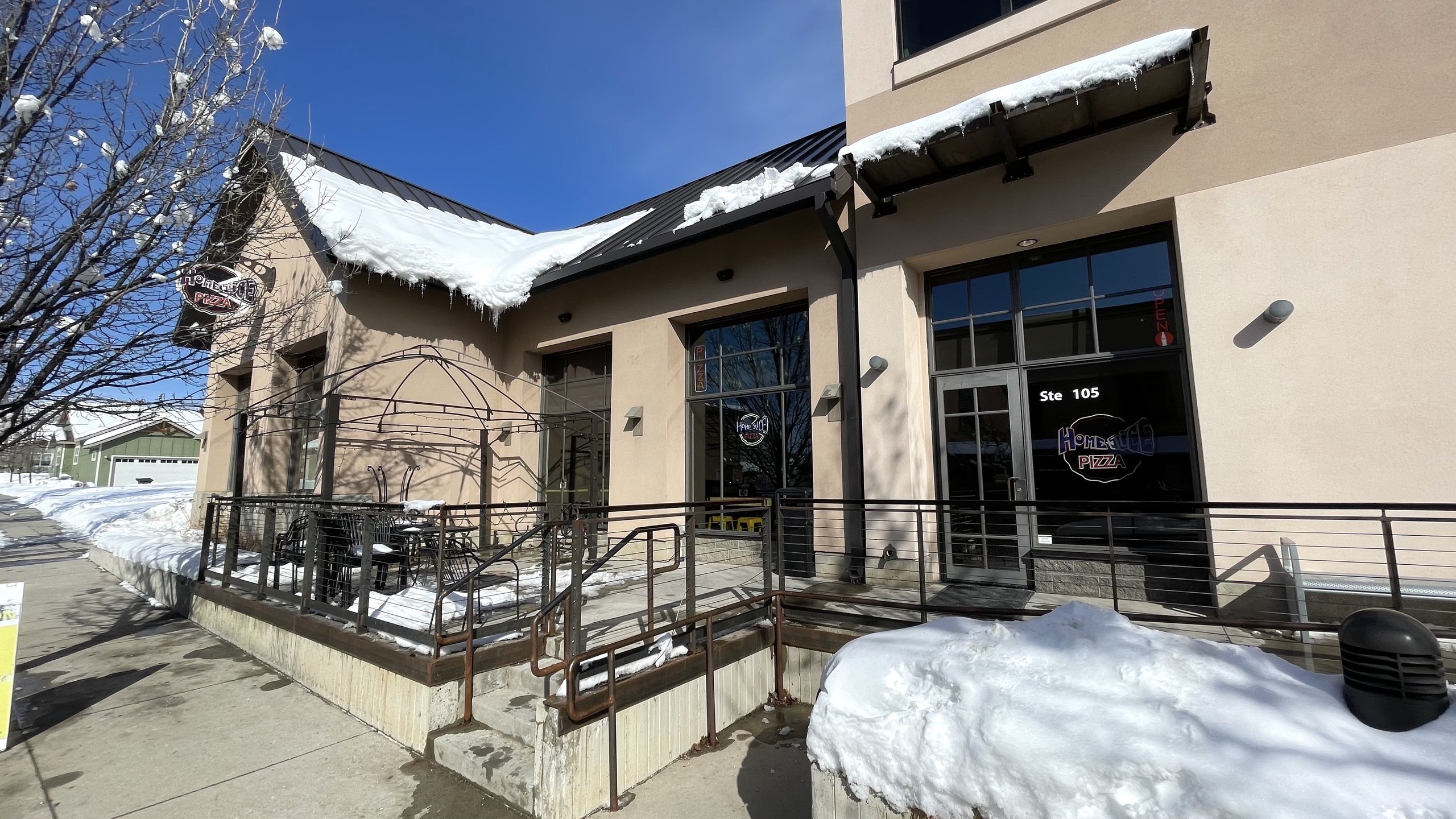 A snowy winter exterior at HomeSlice Pizza Three Springs